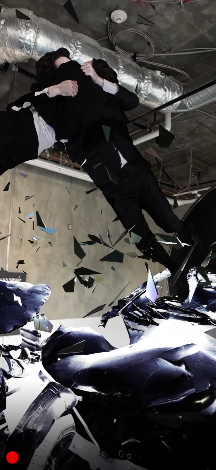 The two figures caught in an embrace mid-air, above the wreck, seen through a phone at West Hollywood project space.