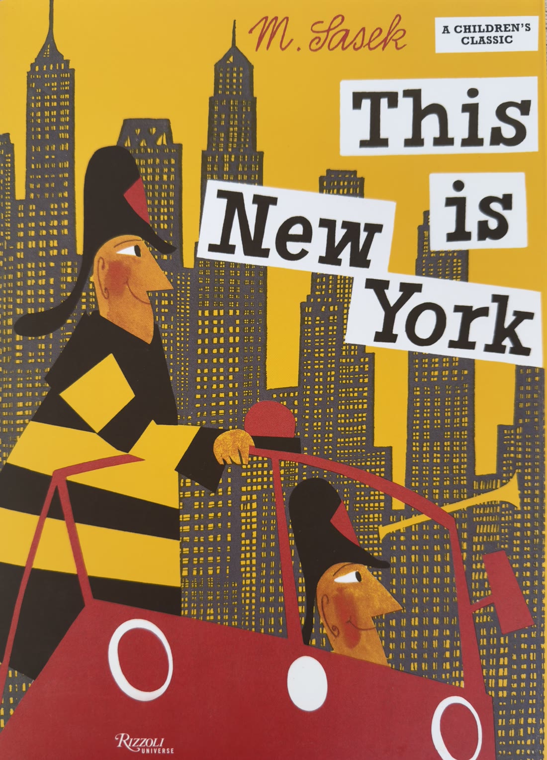 Book cover of This Is New York by Miroslav Šasek—Joey the fireman driving a red car against a yellow skyline